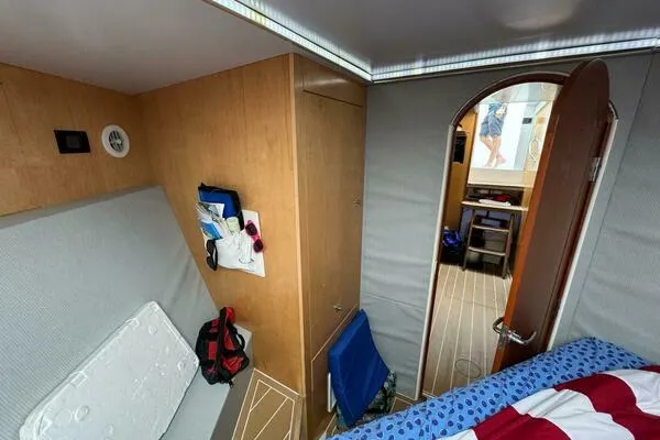 Slide: The Image of Interior cabin of 2002 Luhrs 38 Open boat, featuring cozy seating and storage. - 19