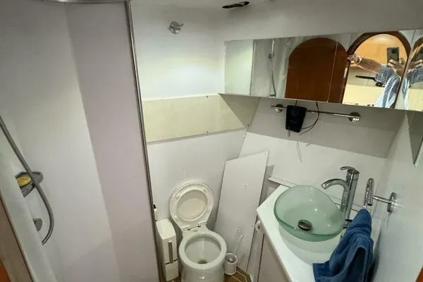 Slide: The Image of 2002 Luhrs 38 Open yacht bathroom with modern sink and toilet. - 22