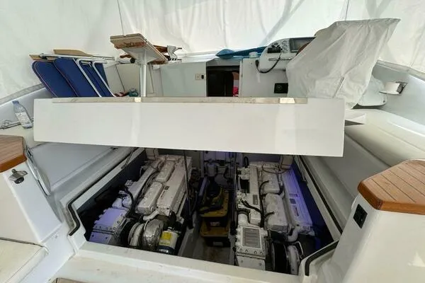 Slide: The Image of Engine compartment of 2002 Luhrs 38 Open boat, showcasing dual engines and seating area. - 24