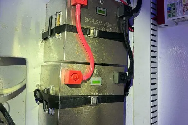Slide: The Image of Battery system in a 2002 Luhrs 38 Open boat with red and black cables. - 25