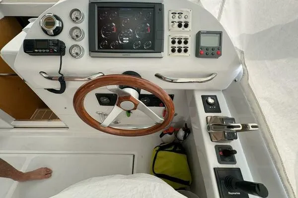Slide: The Image of Helm of 2002 Luhrs 38 Open boat with wooden steering wheel and navigation instruments. - 3