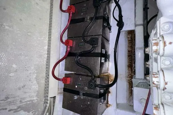 Slide: The Image of Battery compartment of a 2002 Luhrs 38 Open boat with connected cables. - 31