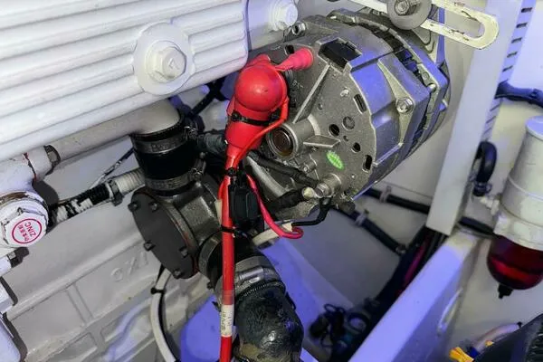 Slide: The Image of Engine compartment of a 2002 Luhrs 38 Open boat, featuring mechanical components and wiring. - 32