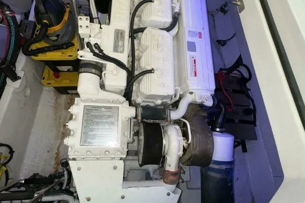 Slide: The Image of Engine compartment of a 2002 Luhrs 38 Open boat, showcasing mechanical components. - 34