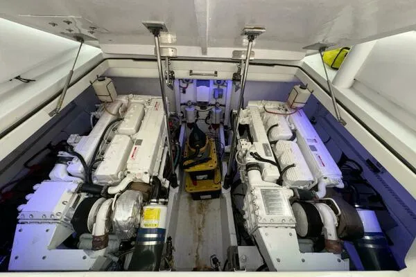 Slide: The Image of Engine room of 2002 Luhrs 38 Open boat, featuring dual engines and mechanical components. - 35