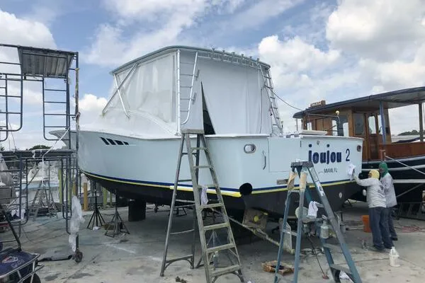 Slide: The Image of 2002 Luhrs 38 Open boat under maintenance with scaffolding and ladders. - 37