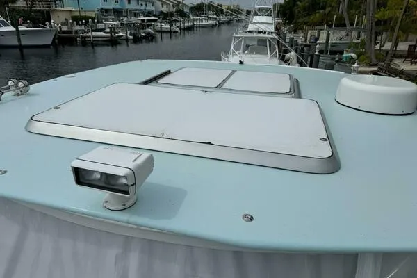 Slide: The Image of 2002 Luhrs 38 Open boat deck with hatches and spotlight, docked in a marina. - 6