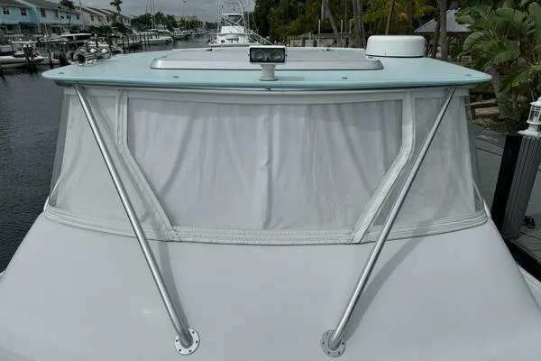 Slide: The Image of 2002 Luhrs 38 Open boat with covered windshield and marina background. - 7