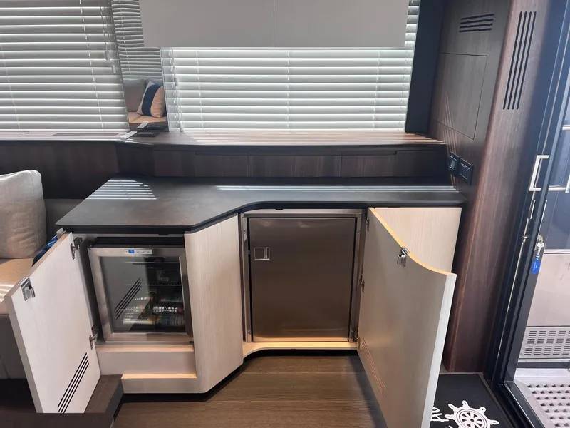 Slide: The Image of 2024 Astondoa AS5 yacht interior with modern kitchenette and open cabinets. - 15