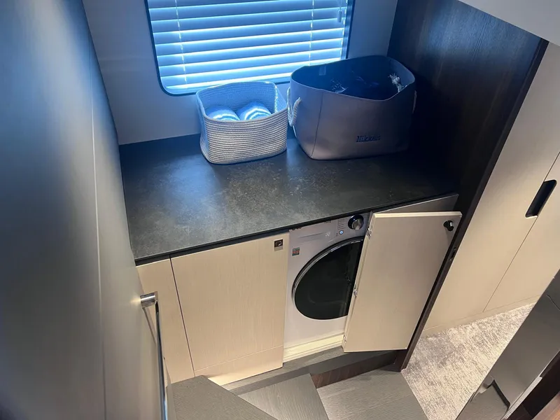 Slide: The Image of Laundry area in 2024 Astondoa AS5 yacht with washer and storage baskets. - 22