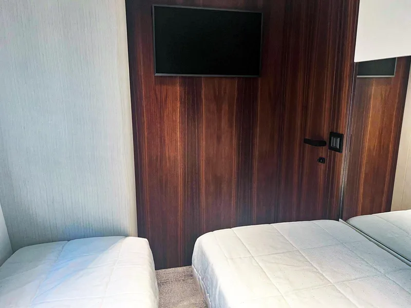 Slide: The Image of Luxurious 2024 Astondoa AS5 yacht bedroom with twin beds and wall-mounted TV. - 33