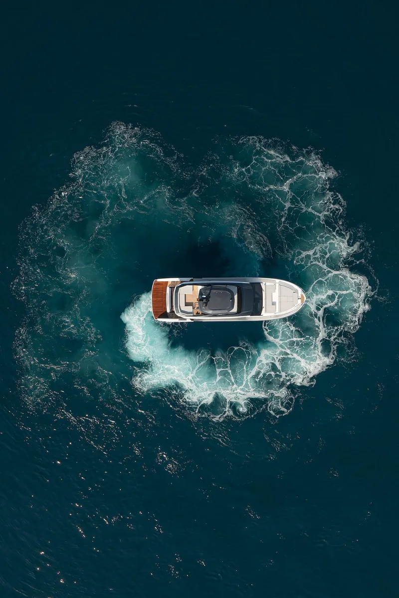Slide: The Image of Aerial view of 2024 Astondoa AS5 yacht creating circular wake in deep blue water. - 4