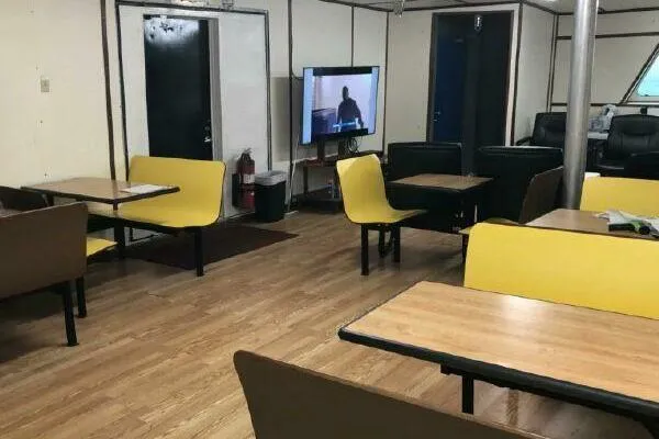 Slide: The Image of Interior of AlumaCat 100, 2000 model, with yellow seating and a TV. - 11