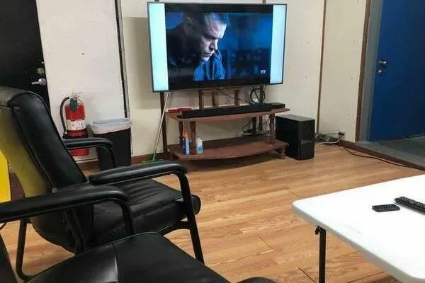 Slide: The Image of Cozy room with TV, black chairs, and wooden floor, featuring AlumaCat 100 model. - 15