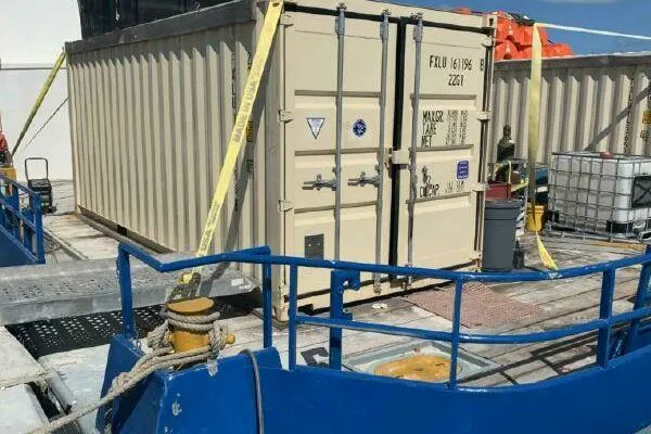 Slide: The Image of AlumaCat 100 container from 2000 on a ship deck with safety straps. - 23