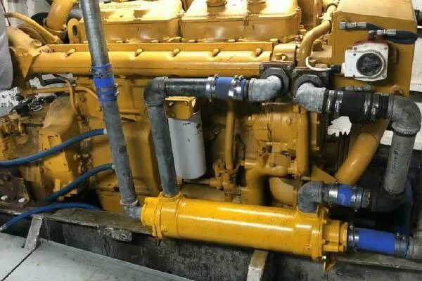 Slide: The Image of Yellow AlumaCat 100 engine from 2000 with visible pipes and components. - 28