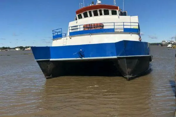 Slide: The Image of Blue and white AlumaCat 100 catamaran on water, 2000 model. - 3