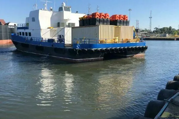 Slide: The Image of AlumaCat 100 vessel from 2000 docked in a harbor, carrying cargo containers. - 6