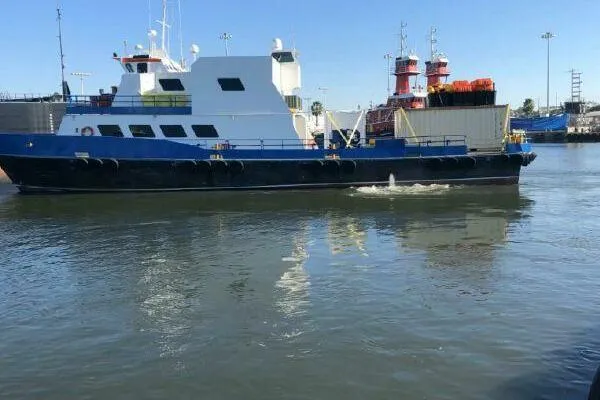 Slide: The Image of AlumaCat 100 vessel from 2000 on calm waters, docked near industrial area. - 7