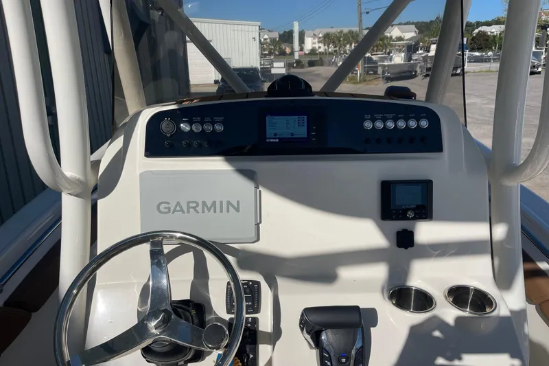 Slide: The Image of 2024 Pioneer 222 Islander boat dashboard with Garmin navigation system and steering wheel. - 13