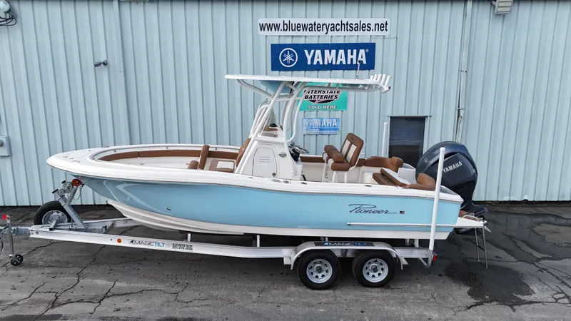Slide: The Image of 2024 Pioneer 222 Islander boat on trailer, displayed at Bluewater Yacht Sales with Yamaha engine. - 1