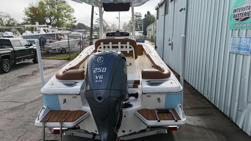 Slide: The Image of 2024 Pioneer 222 Islander boat with Yamaha 250 V6 engine, docked outdoors. - 4