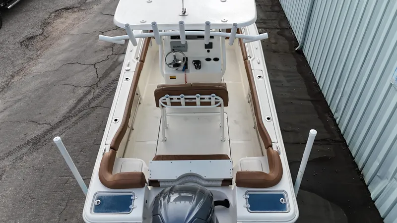 Slide: The Image of 2024 Pioneer 222 Islander boat interior with seating and steering console. - 4