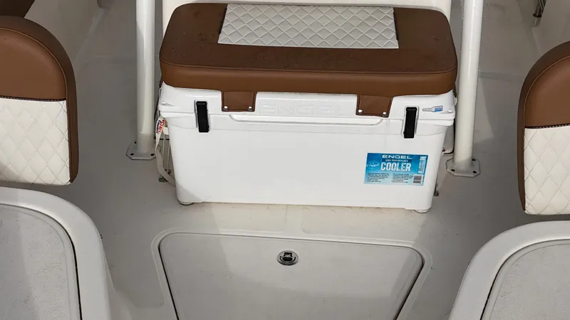Slide: The Image of 2024 Pioneer 222 Islander boat interior with Engel cooler and cushioned seating. - 12