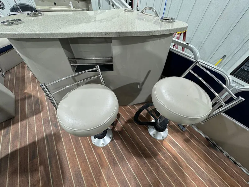 Slide: The Image of 2014 Berkshire 250E STS boat interior with bar stools and countertop. - 10