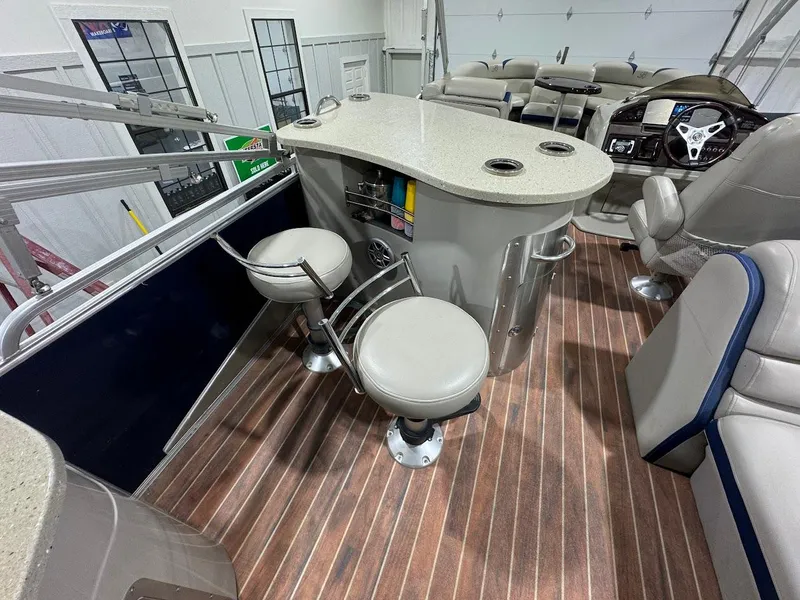 Slide: The Image of Interior of a 2014 Berkshire 250E STS pontoon boat with bar seating and steering console. - 15