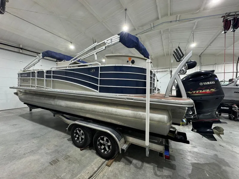 Slide: The Image of 2014 Berkshire 250E STS pontoon boat on trailer in indoor storage facility. - 3