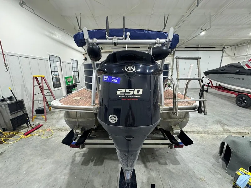 Slide: The Image of 2014 Berkshire 250E STS pontoon boat with Yamaha 250 engine in a garage setting. - 4
