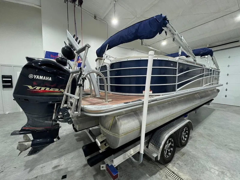 Slide: The Image of 2014 Berkshire 250E STS pontoon boat with Yamaha engine on trailer in indoor storage. - 5