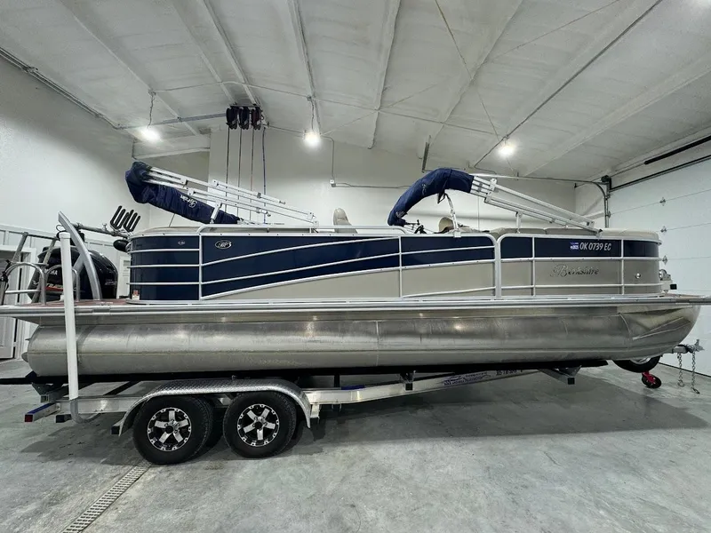 Slide: The Image of 2014 Berkshire 250E STS pontoon boat on trailer in a spacious indoor garage. - 6