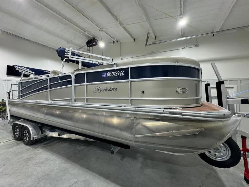 Slide: The Image of 2014 Berkshire 250E STS pontoon boat on trailer in indoor storage facility. - 7