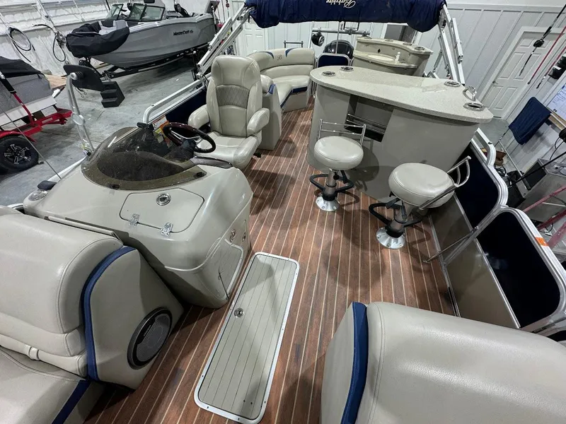 Slide: The Image of 2014 Berkshire 250E STS pontoon boat interior with seating and helm. - 9
