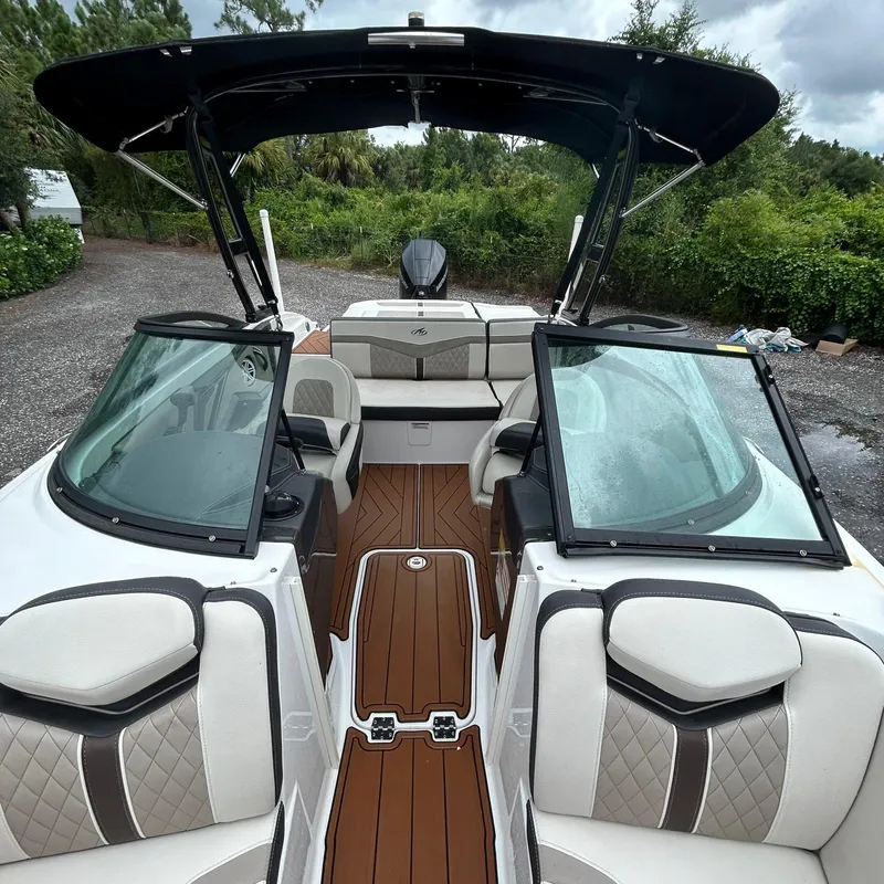 Slide: The Image of 2021 Monterey 215 Super Sport boat with sleek interior and open cockpit design. - 11
