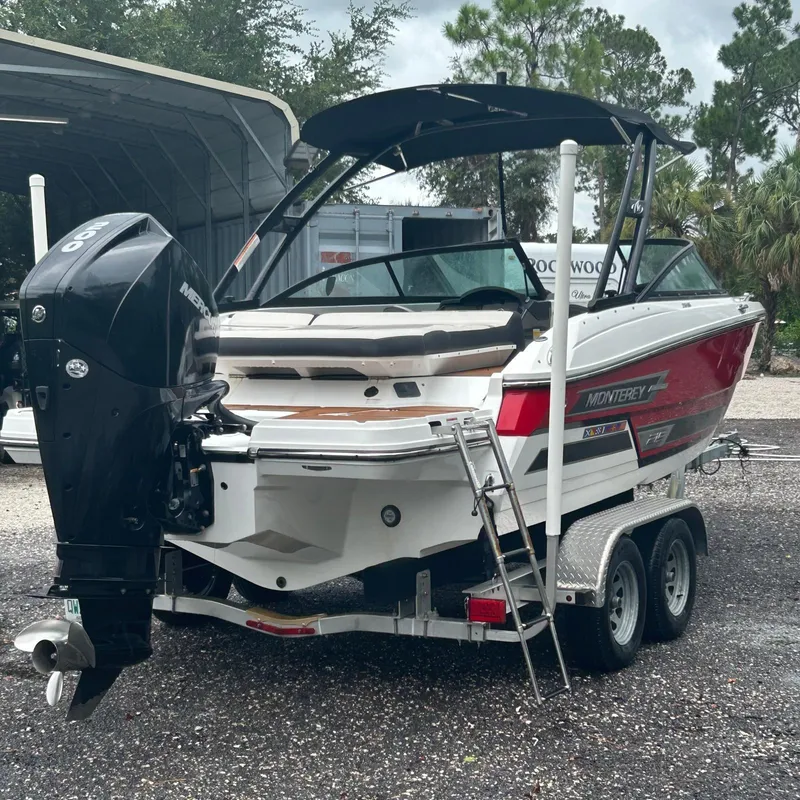 Slide: The Image of 2021 Monterey 215 Super Sport boat on trailer with outboard motor. - 16