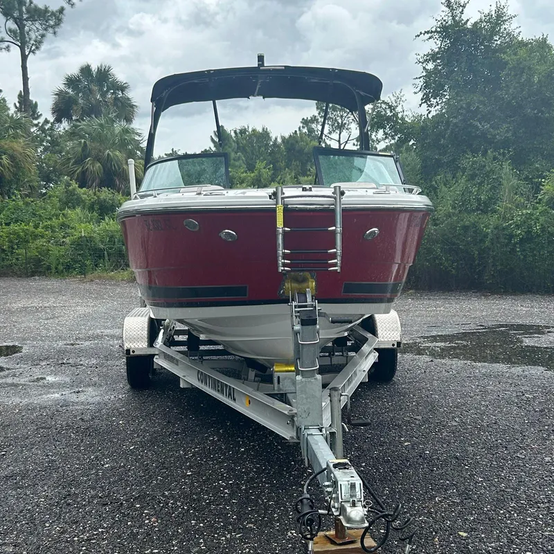 Slide: The Image of 2021 Monterey 215 Super Sport boat on trailer, parked outdoors. - 18