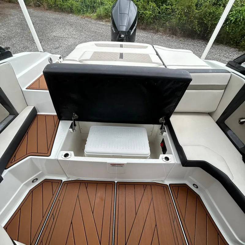 Slide: The Image of 2021 Monterey 215 Super Sport boat interior with seating and storage. - 6