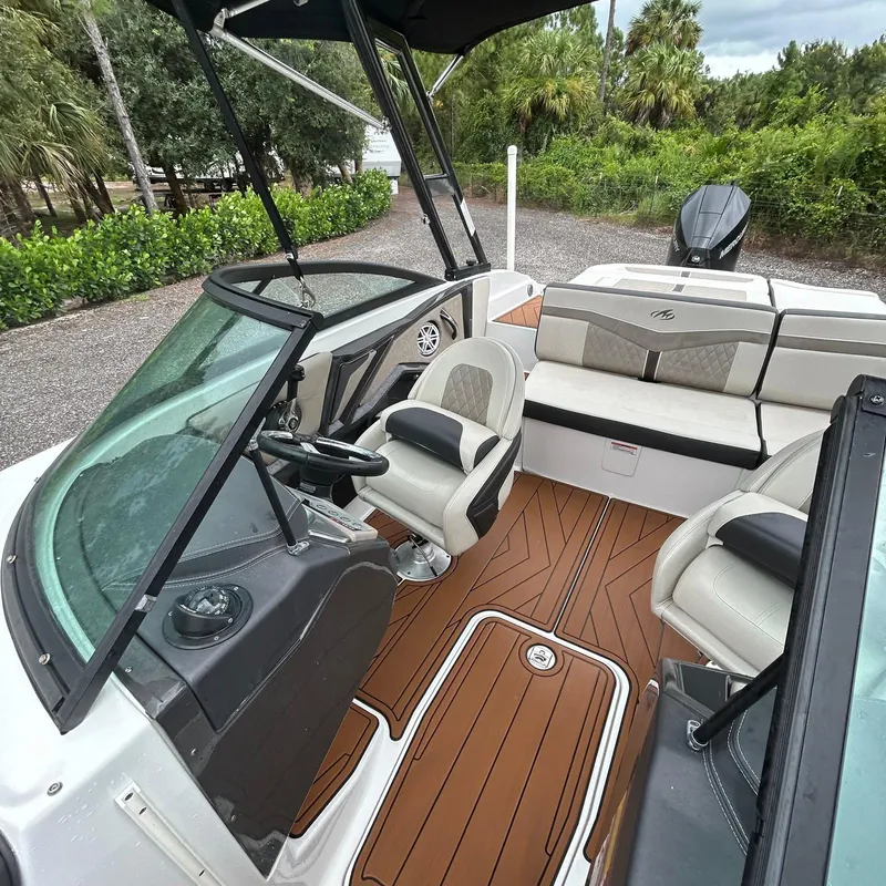 Slide: The Image of 2021 Monterey 215 Super Sport boat interior with seating and steering wheel. - 8