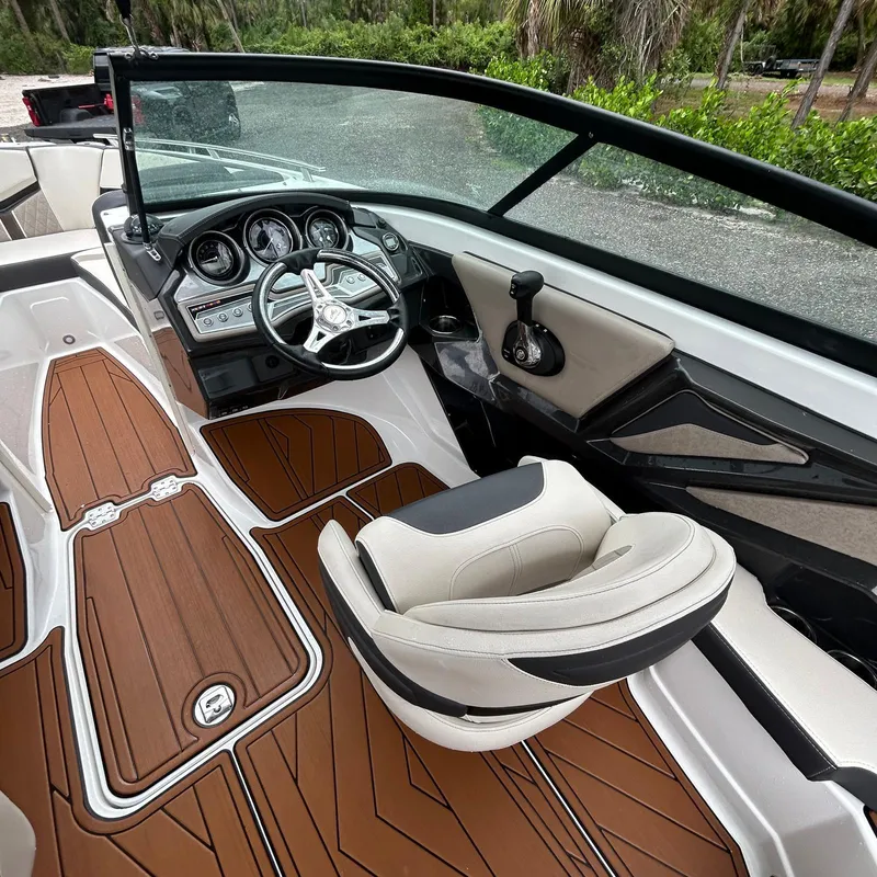 Slide: The Image of 2021 Monterey 215 Super Sport boat interior with sleek dashboard and seating. - 9