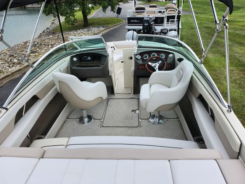 Slide: The Image of 2010 Sea Ray 210 Select boat interior with dual seats and dashboard view. - 10