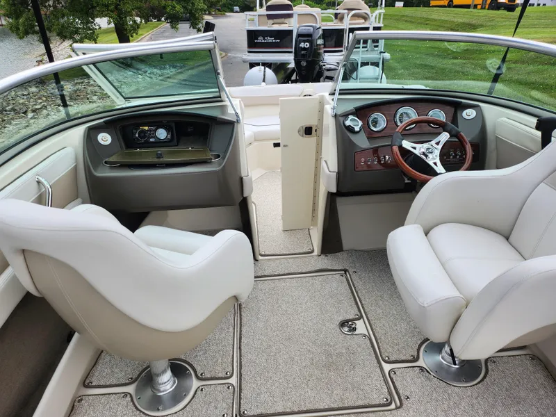 Slide: The Image of 2010 Sea Ray 210 Select boat interior with white seats and modern dashboard. - 11