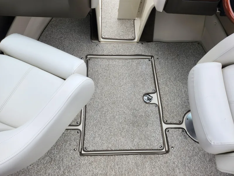 Slide: The Image of Interior of 2010 Sea Ray 210 Select boat with gray carpet and white seats. - 12