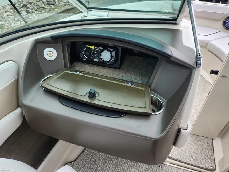 Slide: The Image of Sea Ray 210 Select 2010 boat dashboard with radio and storage compartment. - 16