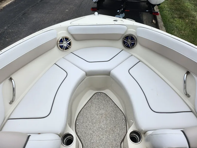 Slide: The Image of 2010 Sea Ray 210 Select boat interior with white seating and cup holders. - 17