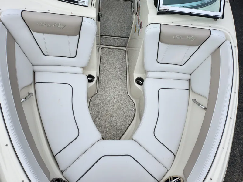 Slide: The Image of 2010 Sea Ray 210 Select boat interior with white cushioned seating. - 19