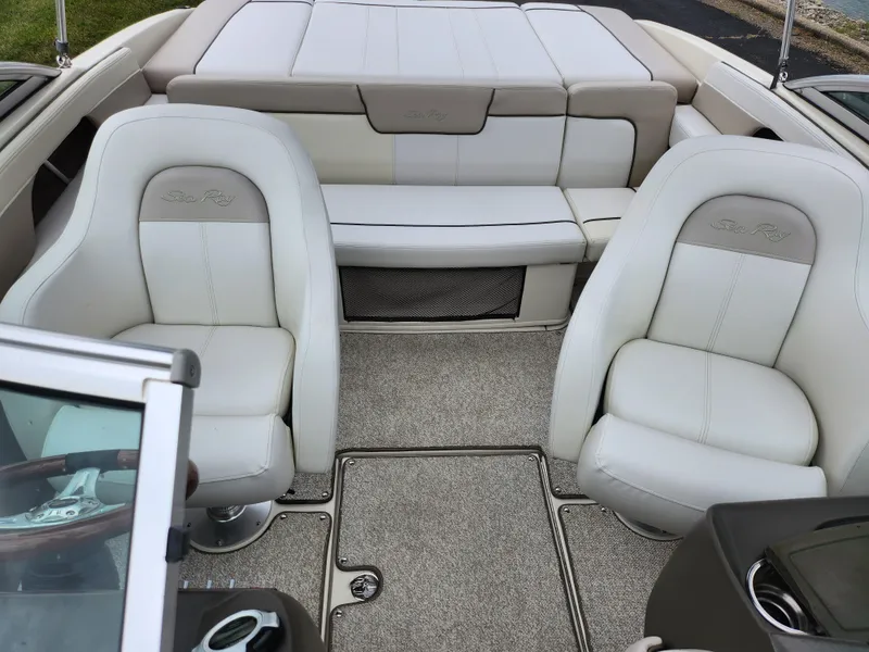 Slide: The Image of 2010 Sea Ray 210 Select boat interior with plush seating and carpeted flooring. - 21