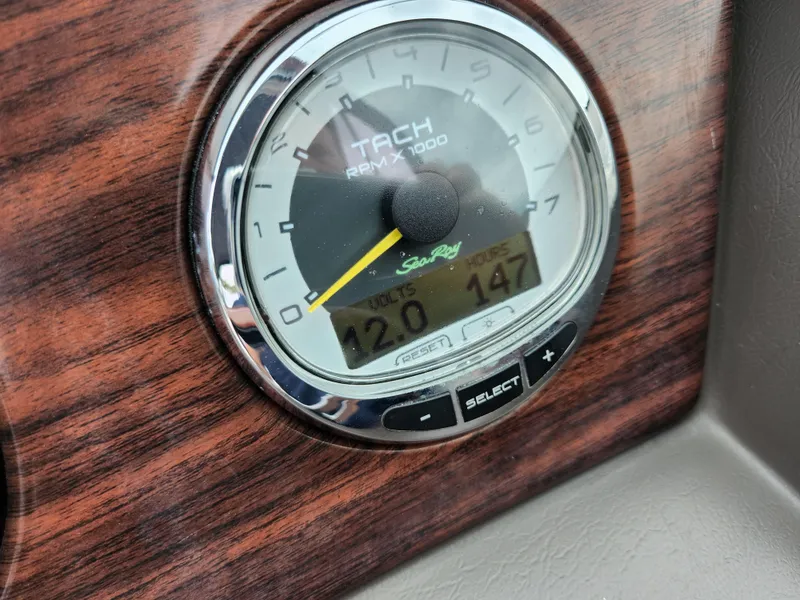 Slide: The Image of Tachometer of 2010 Sea Ray 210 Select boat on wooden dashboard. - 22